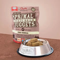 Primal Freeze-Dried Dog Food package with a bowl of nuggets on a brown surface
